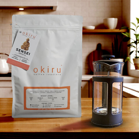 okiru coffee roasters SENSEI package on a wooden table with a french press 