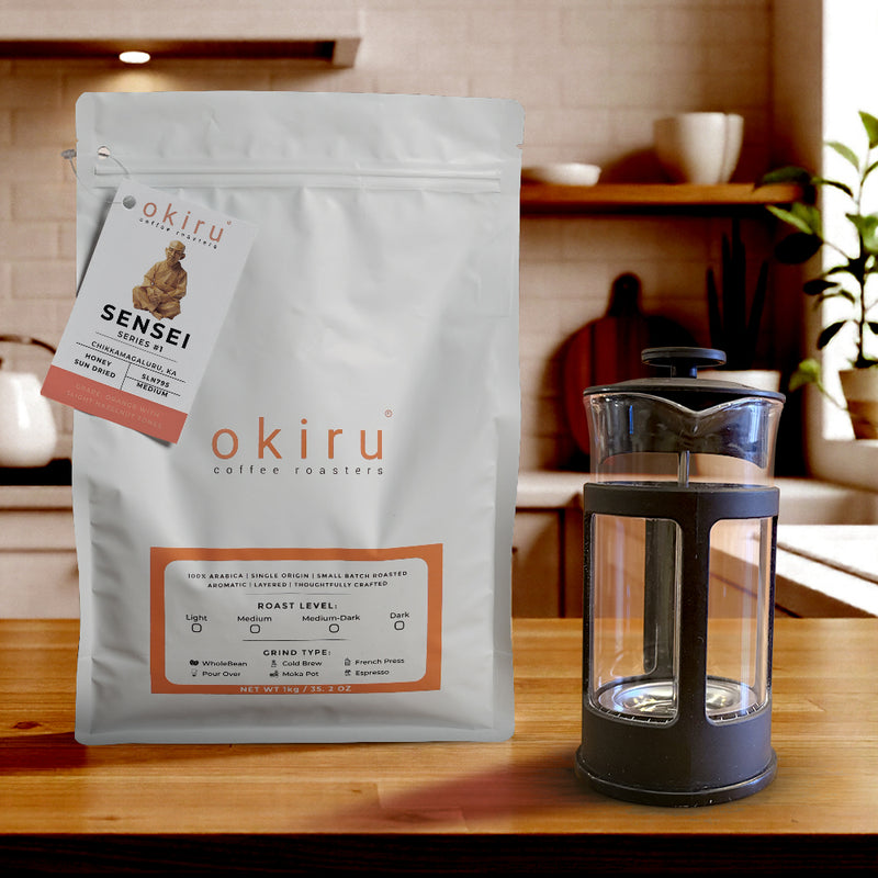 okiru coffee roasters SENSEI package on a wooden table with a french press 