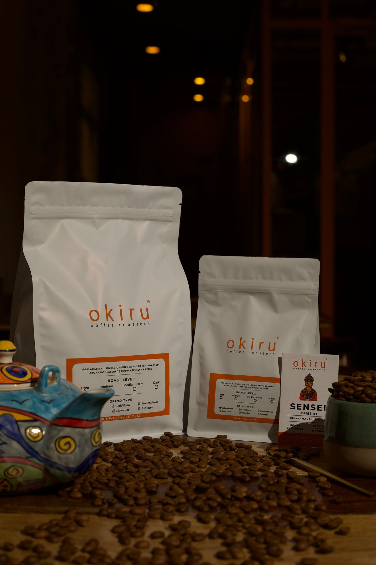 Two coffee bags with 'okiru' branding on a dark background