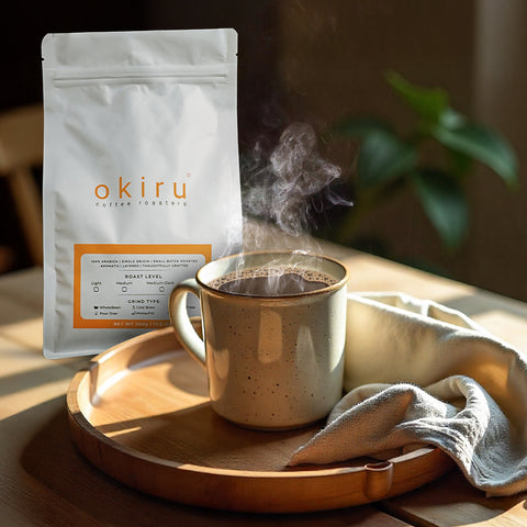 Steaming cup of coffee on a wooden tray with tora coffee package in the background